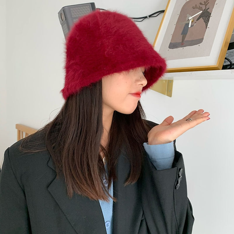 fur bucket hat on model in red side view 