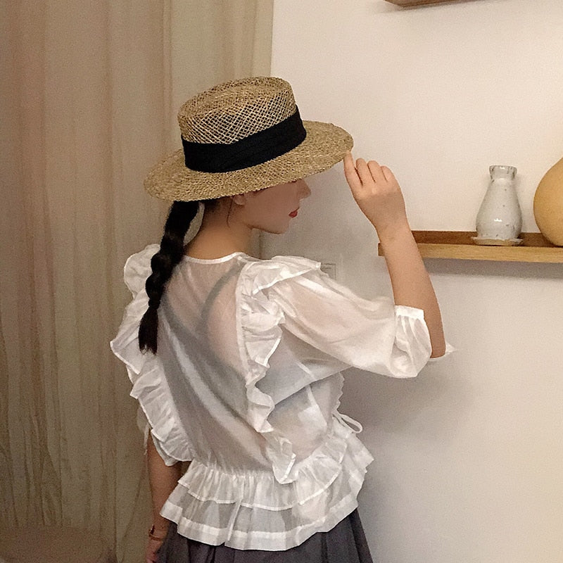 straw fedora hat on a model showing side view 