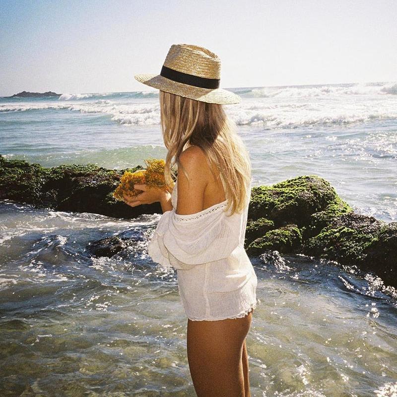 womens straw hat on moedl at the beach