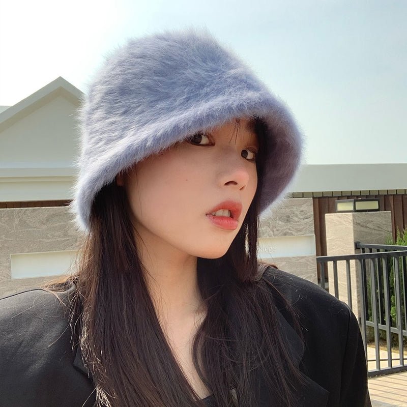 fur bucket hat on model in grey side view 