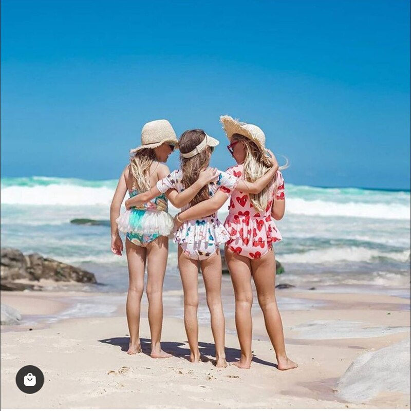 cute straw hat showing mom and daughter at the beach wearing the matching hat