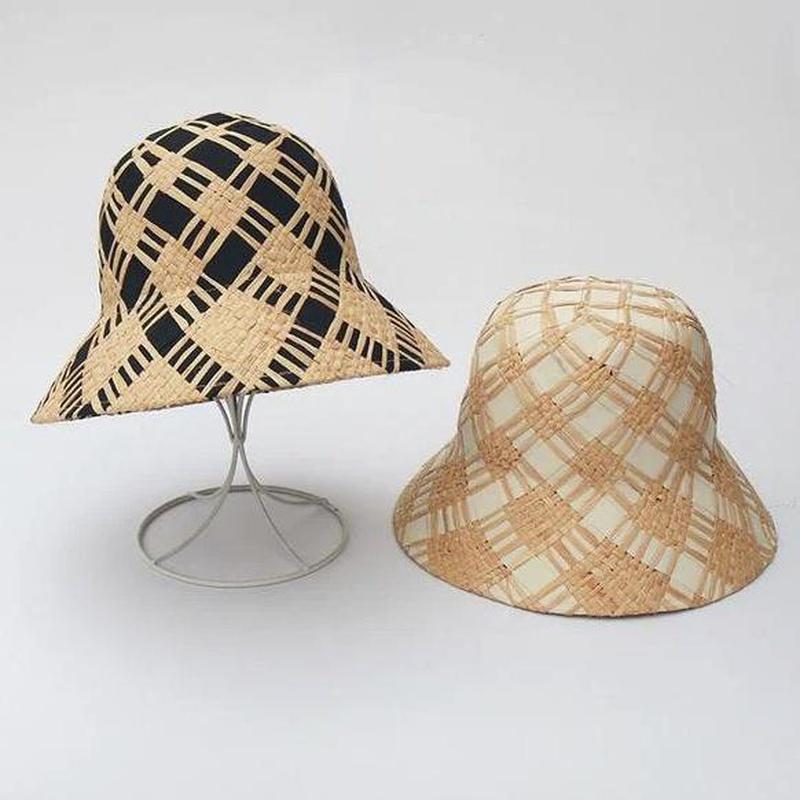bucket hat straw showing black and white options on stand