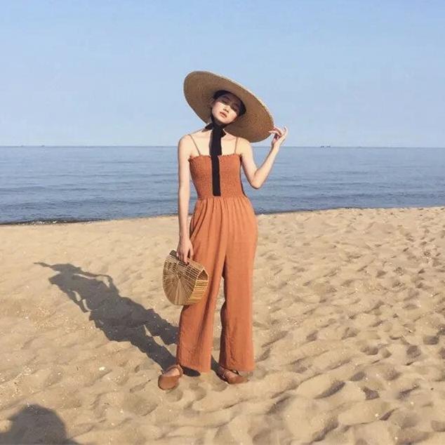 ribbon hat staw sun hat on model at beach full body view 