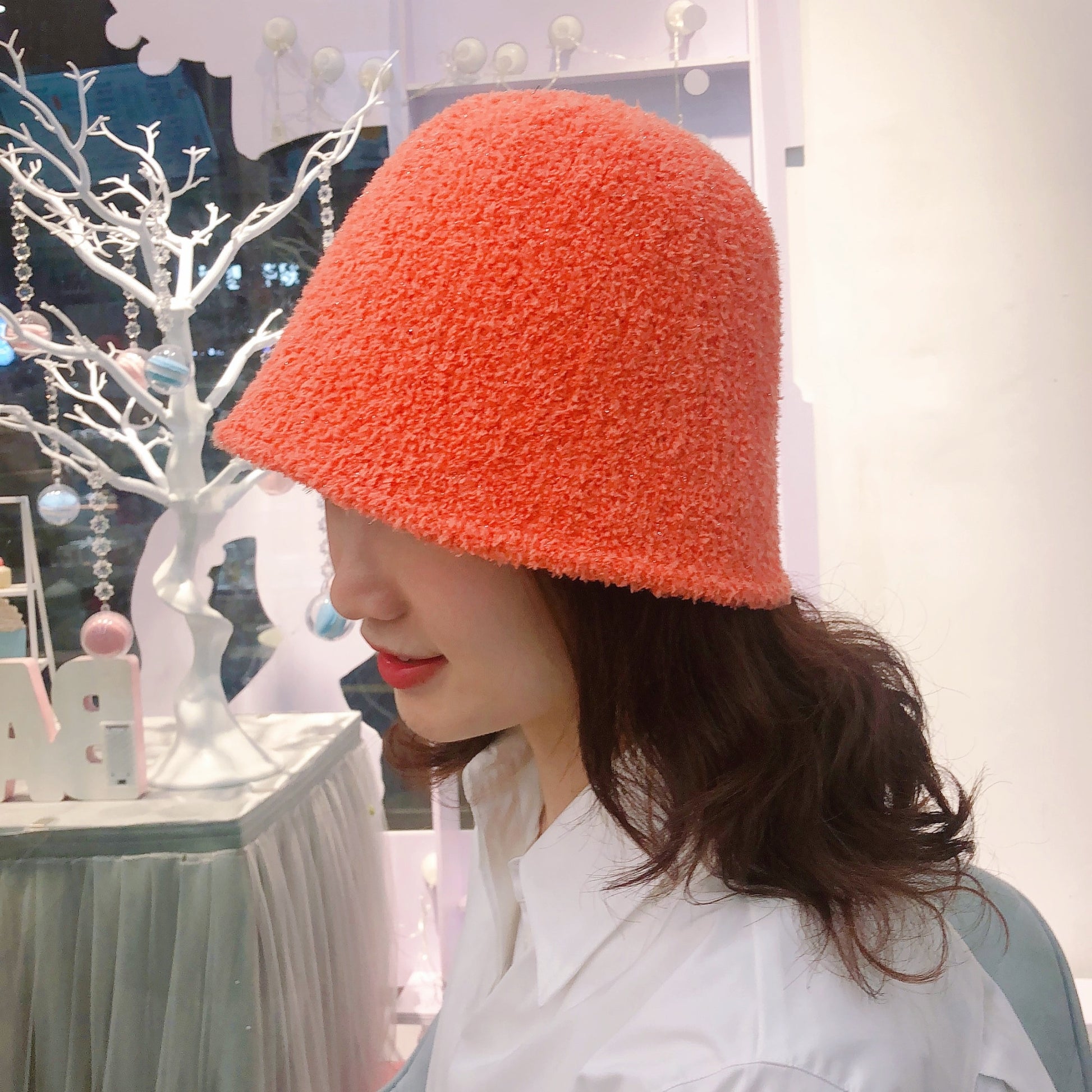 Fuzzy Bucket Hat on model in orange side view 
