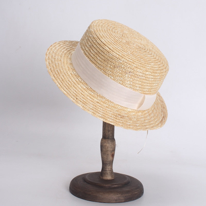 flat straw hat on stand with 2 inch brim