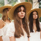 womens straw hat with a group of women earing the hat