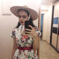 ribbon hat on model taking a selfie