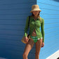 crochet bucket hat on model at beach