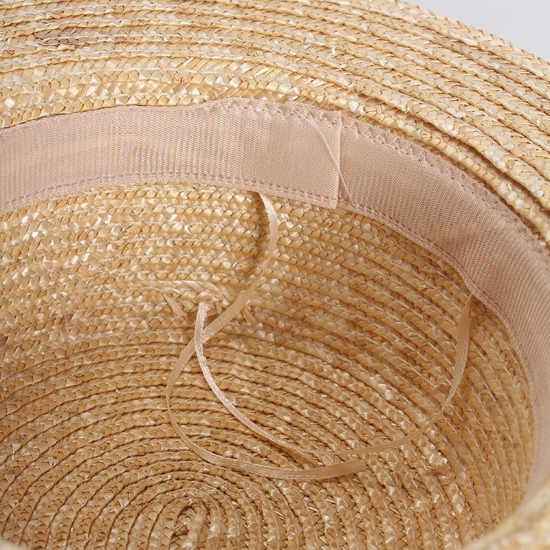flat straw hat showing inside of hat