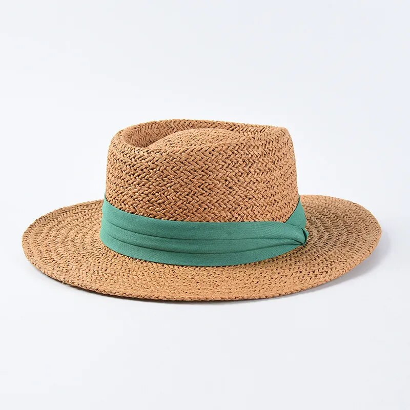 straw sun hat with green ribbon on brown colored hat 