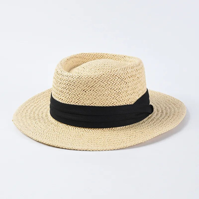 straw sun hat with black ribbon on light colored hat