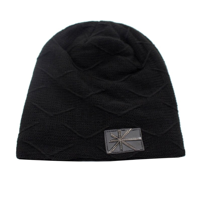 cable knit beanie in black on white background 