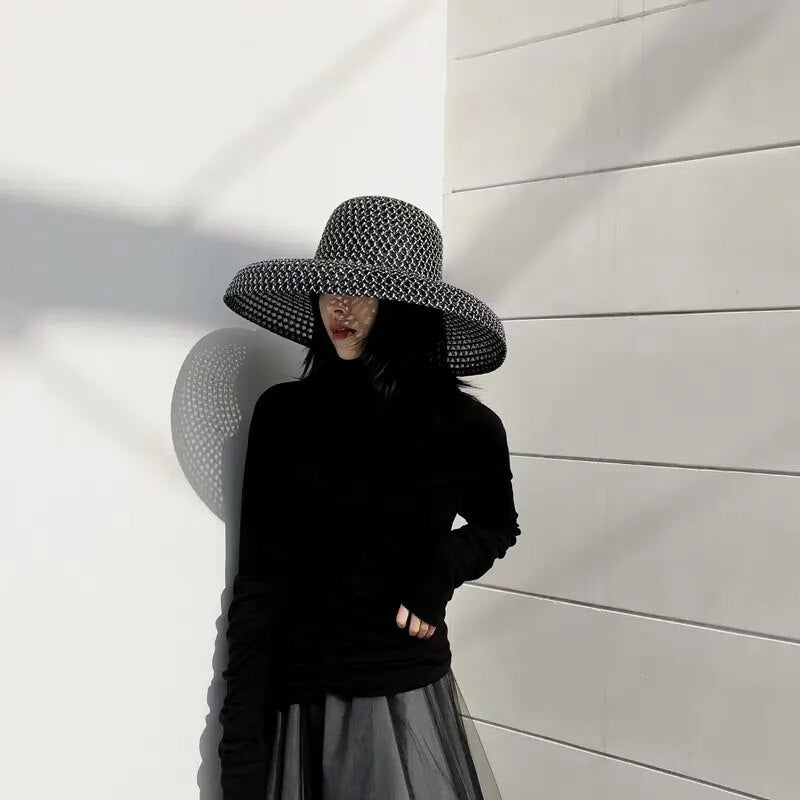 wide brimmed sun hat far away showing full body of model with the hat on her head