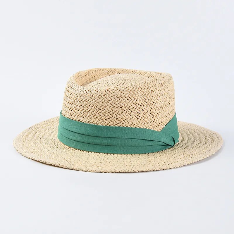 straw sun hat with green ribbon on light colored hat 
