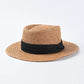 straw sun hat with black ribbon on brown colored hat