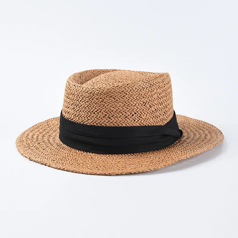 straw sun hat with black ribbon on brown colored hat