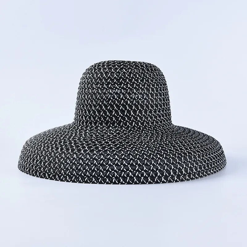 wide brimmed sun hat in black on solid background 