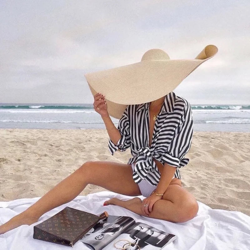 wide brim hats for women on model at beach 