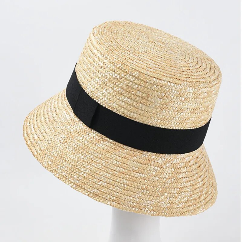 straw bucket hat on stand showing front view with black ribbon