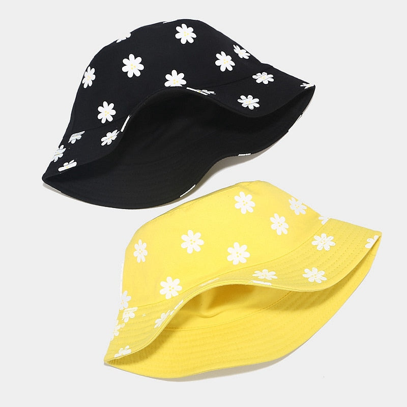flower bucket hat showing black and yellow hats laying flat