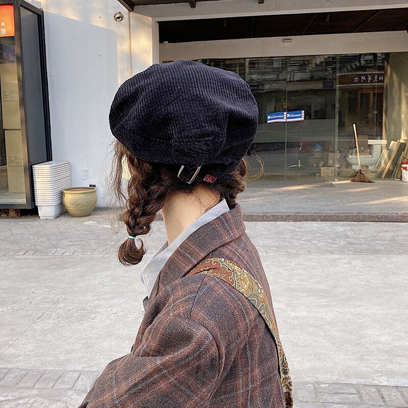 artist hat on model in black back view