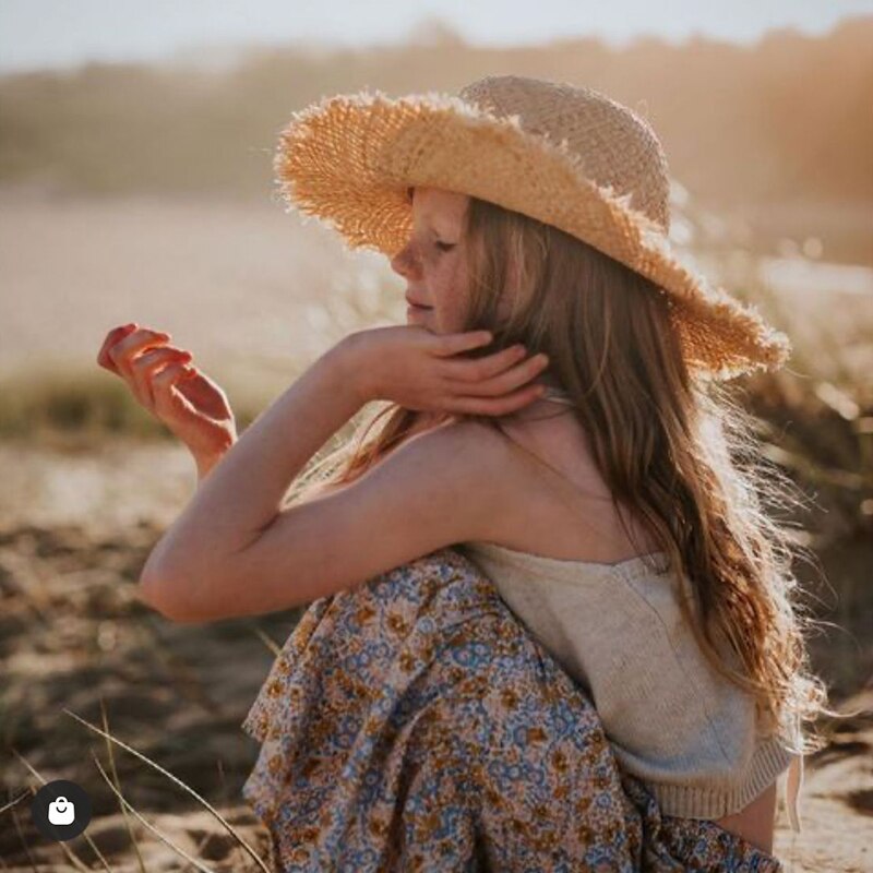 cute straw hat on a child model at the beach