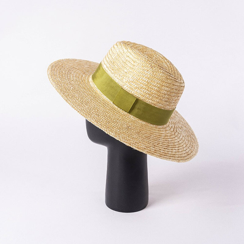 straw hat with ribbon on a stand showing back view