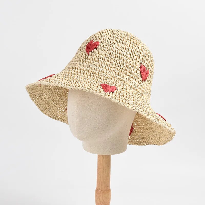 crochet bucket hats on stand front view with heart emblem 