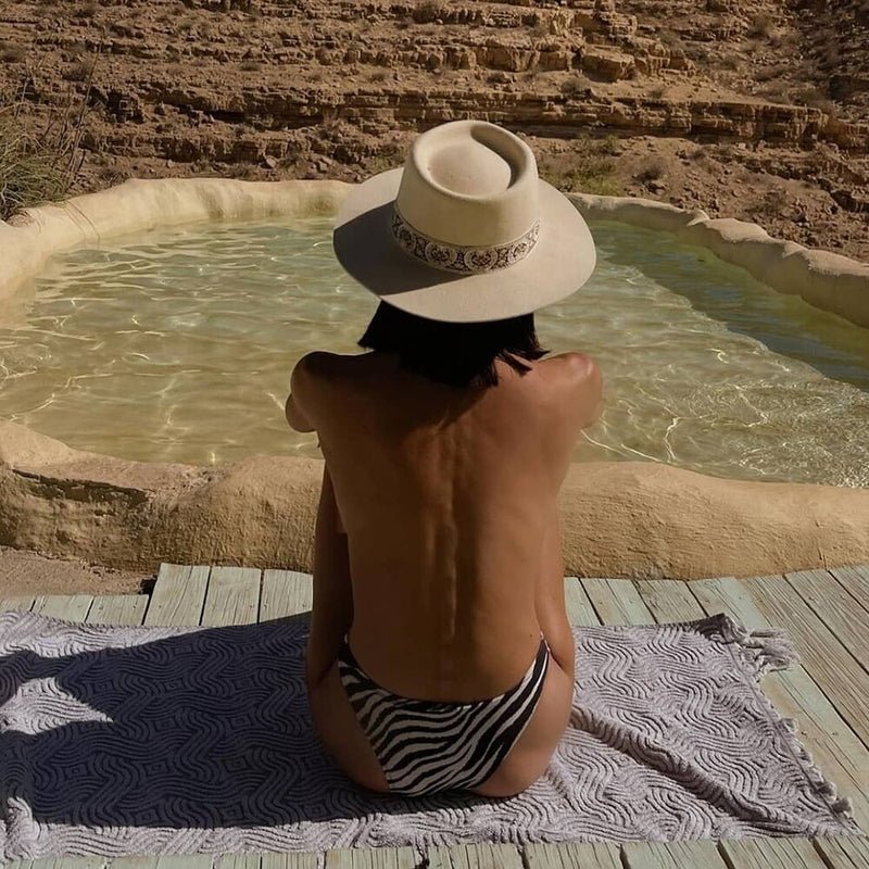 Felt Fedora on model overlooking pool