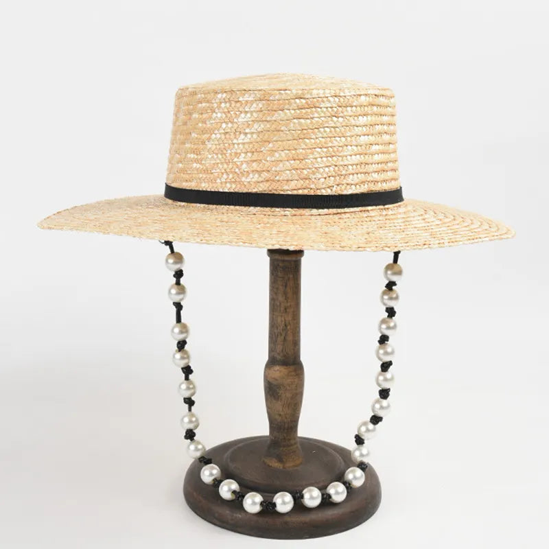 straw hat with pearl chain showing black ribbon hat on stand