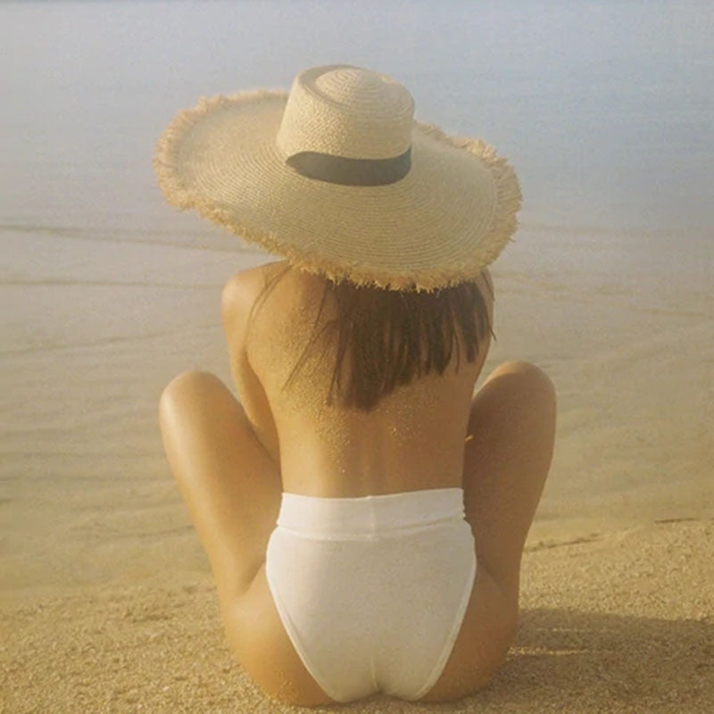 wide brim sun hat on model at beach back view 