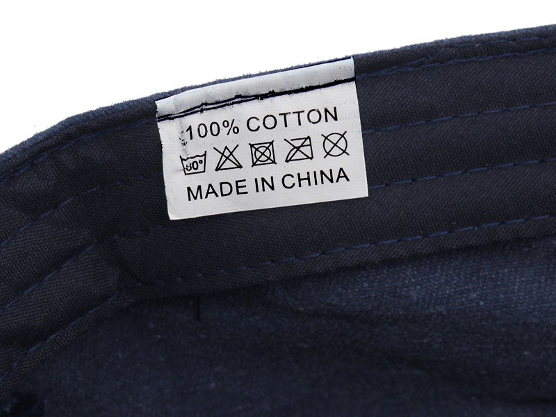 flat topped military hat showing tag that is 100% cotton