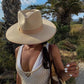 fedora cowboy hat on model with closeup of house