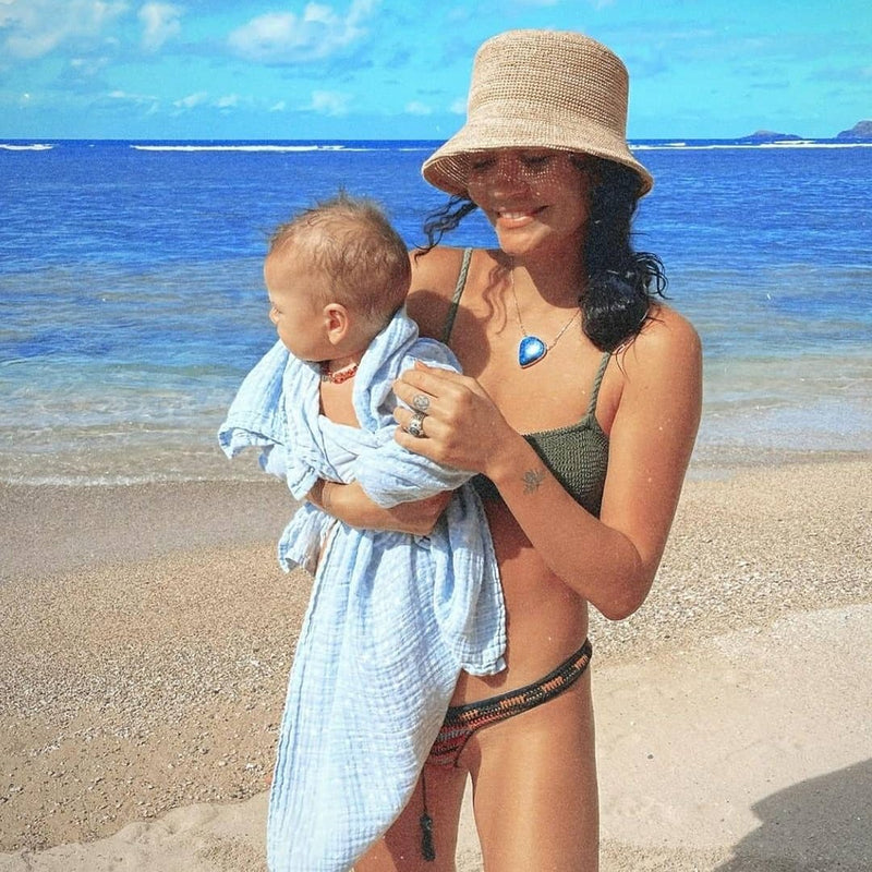 crochet bucket hat on model holding a baby