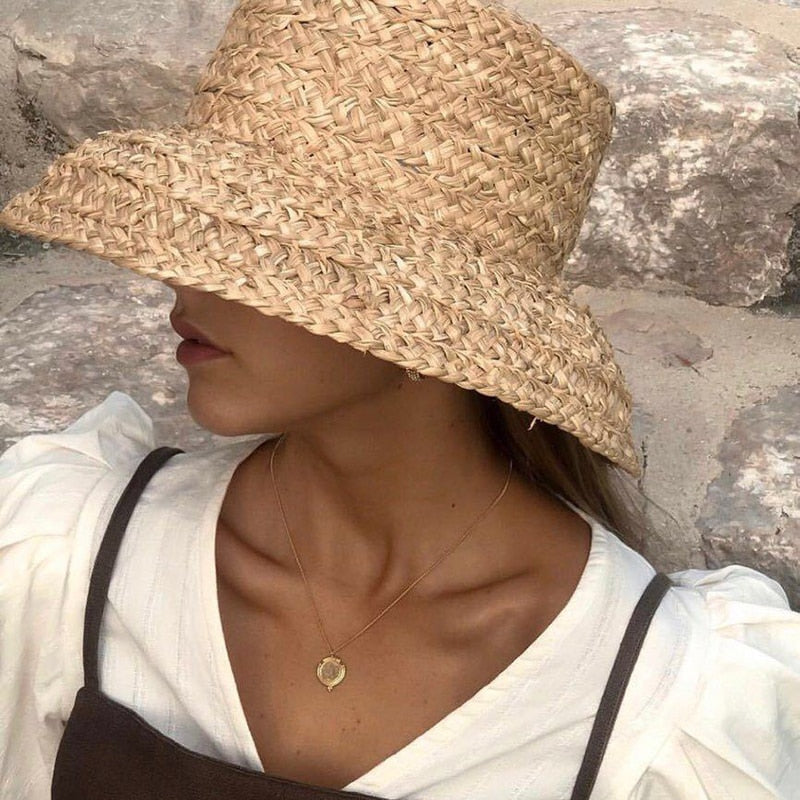 raffia bucket hat on a model showing side view of the hat